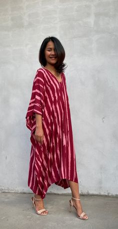 Indulge in the beauty of our classic kaftan with hand silk-screen printed fabric. This kaftan dress boasts unique patterns on high-quality rayon fabric. Its versatile design allows you to create many stylish looks, ensuring you always feel your best, whether you're at home or stepping out. Red Bohemian Kaftan With Ikat Print, Red Flowy V-neck Kaftan, Red V-neck Free Size Kaftan, Red Cotton Maxi Kaftan, Red Bohemian Printed Tunic, Red Printed Maxi Dress For Beach, Flowy Red Printed Kaftan, Red Flowy Kaftan With Kimono Sleeves, Red Bohemian V-neck Kaftan