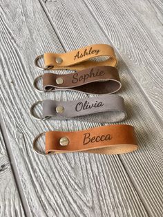 three leather name tags with names on them