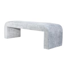 a bench made out of concrete sitting on top of a white floor