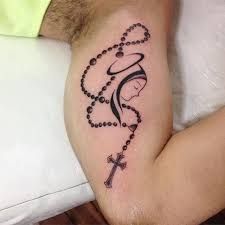 a man with a rosary tattoo on his arm