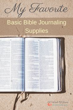 an open bible sitting on top of sand with the words, my favorite basic bible journal