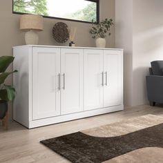 a living room scene with focus on the cabinet and rug in front of the couch