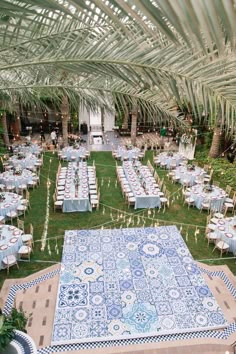 an outdoor venue with tables and chairs set up in the grass for a formal function