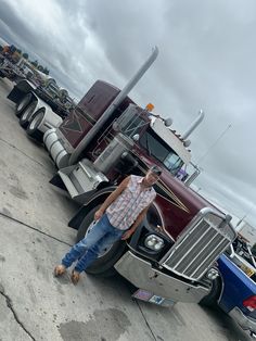 a man standing next to a semi truck