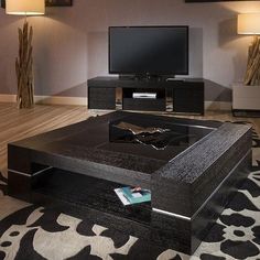 a living room with a large black coffee table