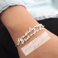 a woman's arm with a name bracelet on it