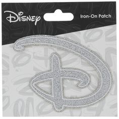 disney iron - on patch with the letter d in silver glitter, sitting on top of a