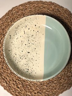 a white and blue plate sitting on top of a wicker basket