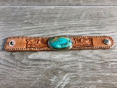 This handmade real turquoise and leather cuff bracelet is one of a kind. You won't find another one just like it. Handmade in Utah in my little home shop. This is the perfect accessory for any outfit. You'll love this beautiful and timeless handcrafted piece. Handmade Western Style Cuff Bracelets, Adjustable Hand Tooled Turquoise Cuff Bracelet, Unique Turquoise Leather Bracelets, Adjustable Turquoise Cuff Bracelet With Concho, Adjustable Turquoise Hand Tooled Cuff Bracelet, Turquoise Leather Cuff Bracelet, Handmade Turquoise Leather Cuff Bracelet, Rustic Handmade Turquoise Cuff Bracelet, Unique Turquoise Cuff Bracelet With Concho