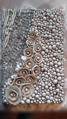 a close up of a piece of art made out of stones