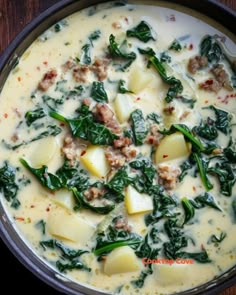 a pan filled with potatoes and spinach on top of a wooden table