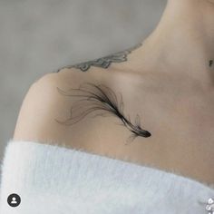 a woman with a feather tattoo on her shoulder