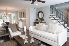 a living room filled with furniture and a stair case