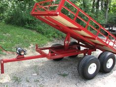 a red trailer that is sitting on the ground