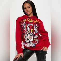 This Unisex Best-Selling Graphic Fleece Pullover Hoodie Is Crafted With A Cotton Blend Jersey And Fleece Finish On Inside. Base Color - Red Featuring Ed Hardy's Iconic Graphic Print On The Front. Including Printed Logos On Left Sleeve And Back. Hood Is Lined With Soft Cotton Jersey Of Matching Color &Drawstring Large Patch Pocket At Front Two-Ply Rib At Hem And Sleeve Bands 55% Cotton 45% Poly Imported Sz L Measurements Center Back Length Incl Cuff - 27” Chest - 49” Sleeve Length Frm Cb Incl Cuff - 37” Sz Xl Measurements Center Back Length Incl Cuff - 27.5” Chest - 51” Sleeve Length Frm Cb Incl Cuff - 38” Fall Punk Hooded Top, Edgy Hooded Fall Sweatshirt, Hip Hop Hoodie Tops For Winter, Hip Hop Hoodie For Winter, Edgy Hooded Sweatshirt With Graphic Print, Edgy Hooded Graphic Print Sweatshirt, Edgy Crew Neck Hoodie For Fall, Edgy Crew Neck Fall Hoodie, Edgy Fall Hoodie Sweatshirt