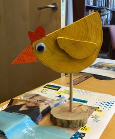 a wooden bird sculpture sitting on top of a table