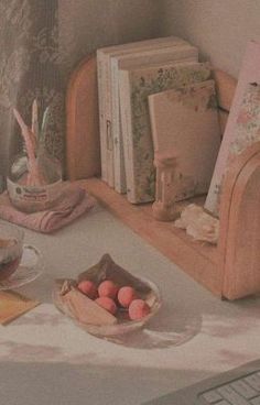 an image of a desk setting with books and other things on the table in front of it