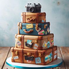 a cake made to look like suitcases stacked on top of each other with cameras