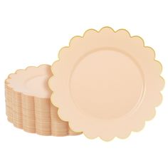 a stack of pink plates with scalloped edges