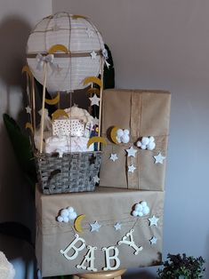 a baby shower cake with balloons, stars and moon decorations on it's side