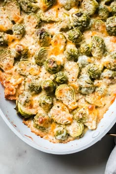 a casserole dish filled with broccoli and cheese