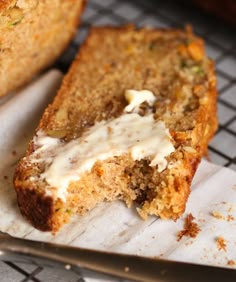 two pieces of bread with white sauce on top and one piece cut off from it