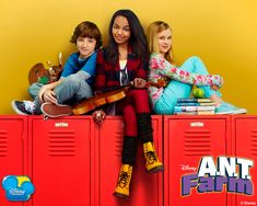 the cast of ant farm sitting on lockers in front of a yellow and orange background