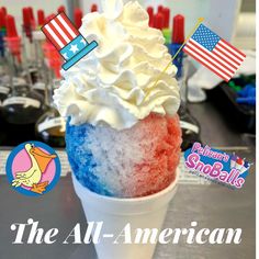 an ice cream sundae with red, white and blue icing in a cup