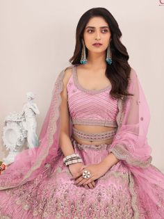 A masterpiece that combines elegance, beauty, and tradition. This pink color lehenga crafted from high-quality net material will make any woman feel like a princess on her special day.
The lehenga is embellished with exquisite embroidery work, sequin work, dori, and zari work, adding a touch of glamour and sophistication. The intricate detailing creates a mesmerizing pattern, making this lehenga a true work of art.
To complete the ensemble, the lehenga comes with a matching net blouse material i Pink Organza Lehenga With Pallu, Pink Sharara For Reception Navratri, Pink Sharara For Reception And Navratri, Pink Organza Sets For Navratri, Pink Wedding Sets For Navratri, Pink Wedding And Navratri Sets, Designer Pink Lehenga With Sheer Dupatta, Pink Organza Anarkali Set With Unstitched Blouse, Pink Organza Sets With Traditional Drape