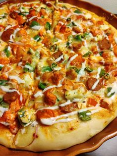 a pizza sitting on top of a pan covered in toppings