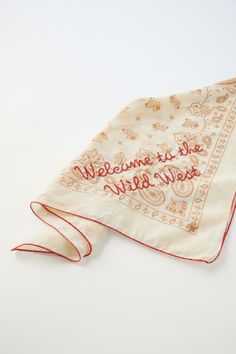 an embroidered handkerchief with the words welcome to us and new home written in cursive writing