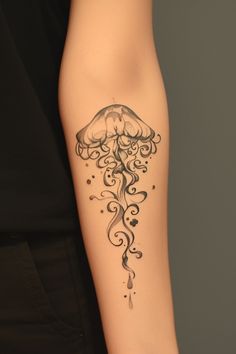 a woman's leg with a tattoo on it that has an image of a jellyfish