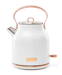 a white tea kettle with copper trimmings and a handle on the top, sitting in front of a white background