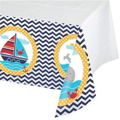 a table cover with a sailboat and whale on it