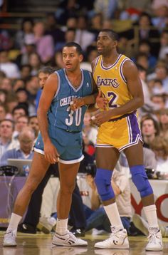 two basketball players standing next to each other on a court