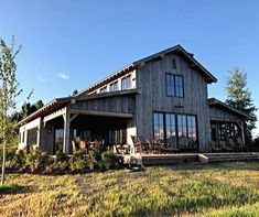 a large house sitting on top of a lush green field