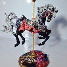 a figurine of two horses on a pole