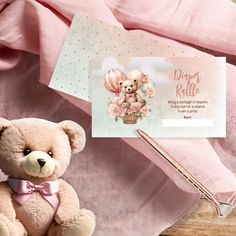 a teddy bear sitting next to a notepad and pen on a pink blanket with a greeting card