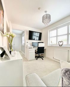 a living room filled with furniture and a flat screen tv on top of a wall