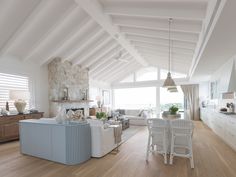 a living room filled with furniture and a fire place in the middle of a kitchen