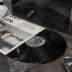 an old vinyl record sitting on top of a table