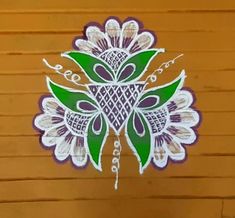 an intricate design on the side of a wooden wall, with green leaves and white flowers