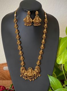 An elegant set for your local gatherings or parties. The length of the antique kemp AD haram is given in one of the pictures. Measurements of the jhumkas. Height: 5.5 Cm  Width : 3.5 Cm  Care Instruction : Avoid Heat & Chemicals Like Perfume, Deo, Alchol, Etc. | Clean With Dry Cotton Cloth | Pack In our Anti tarnish box after use. Lakshmi Haar Gold, Long Temple Jewellery Necklace, Luxury 22k Gold Hallmarked Temple Necklace, Luxury Gold Temple Jewelry Beads, Temple Jewelry Necklace With Peacock Design For Rituals, Temple Necklace With Peacock Design For Rituals, Antique Gold Temple Necklace For Wedding, Gold Zari Weaving Jewelry For Weddings, Gold Wedding Jewelry With Zari Weaving