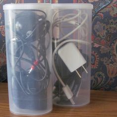 two plastic containers with wires and cords in them