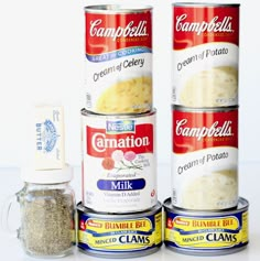 three cans of soup are stacked on top of each other and one can is filled with cream cheese