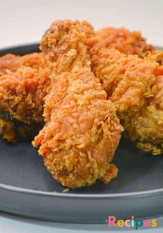 three fried food items on a black plate