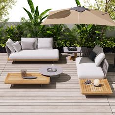 an outdoor living area with couches, coffee table and umbrella on top of the deck