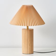 a table lamp made out of wooden strips