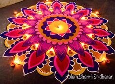 an intricately decorated diya with candles on the floor