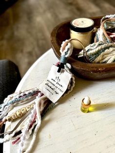 a wooden bowl filled with different types of thread